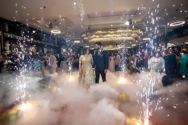 Couple's grand entry with sparklers and fog at the reception